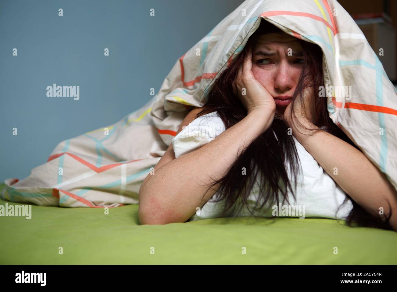 Young woman sleeping under blanket hires stock photography and images