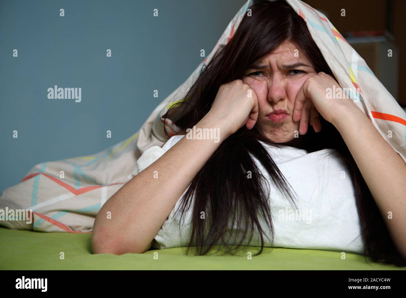 Young woman sleeping under blanket hires stock photography and images