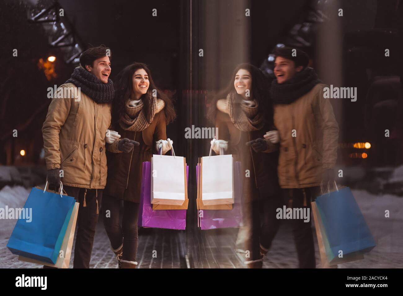 Boyfriend And Girlfriend Doing Shopping Walking In City In Evening Stock Photo