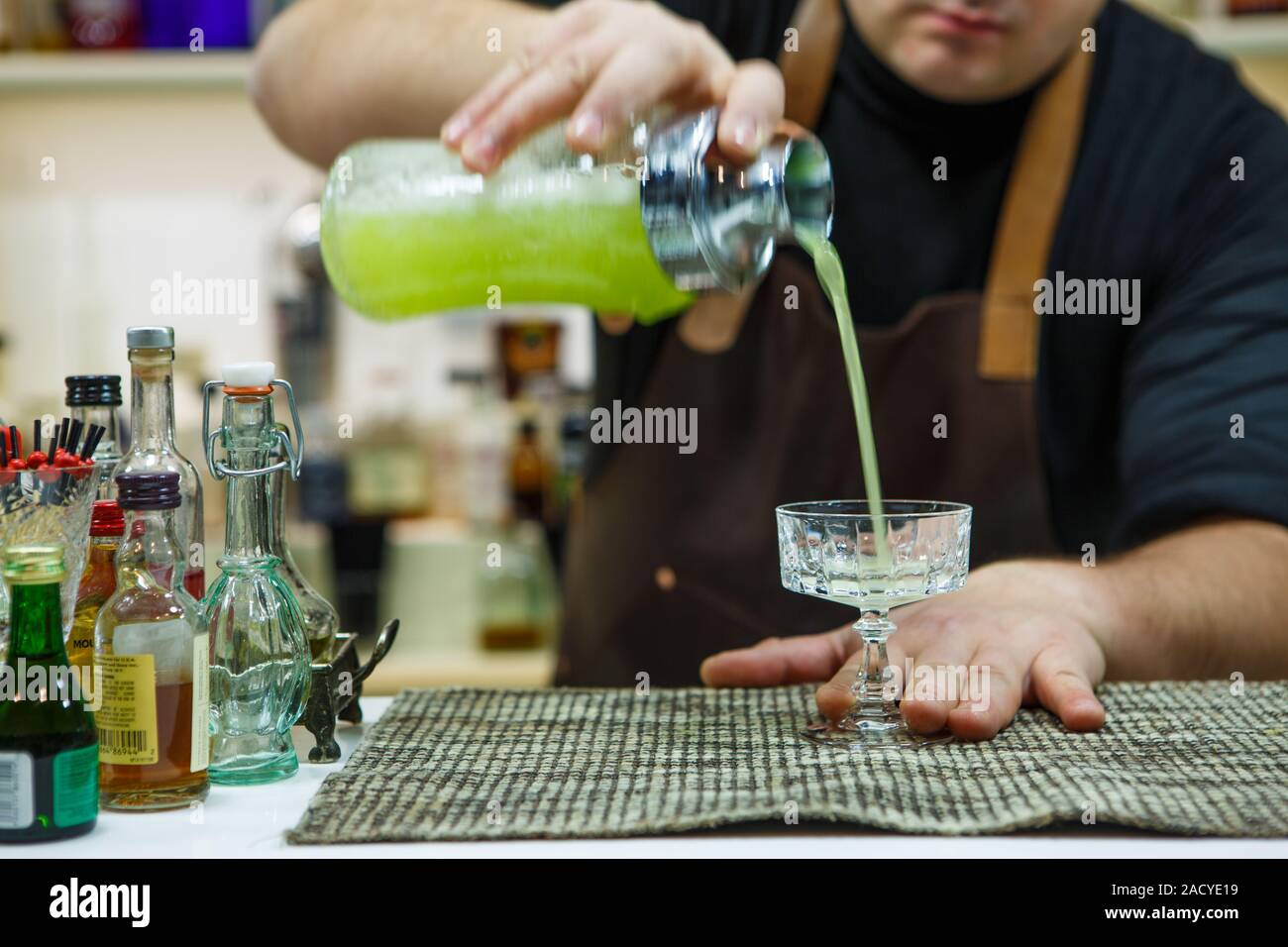 barman pouring a pink cocktail drink Stock Photo