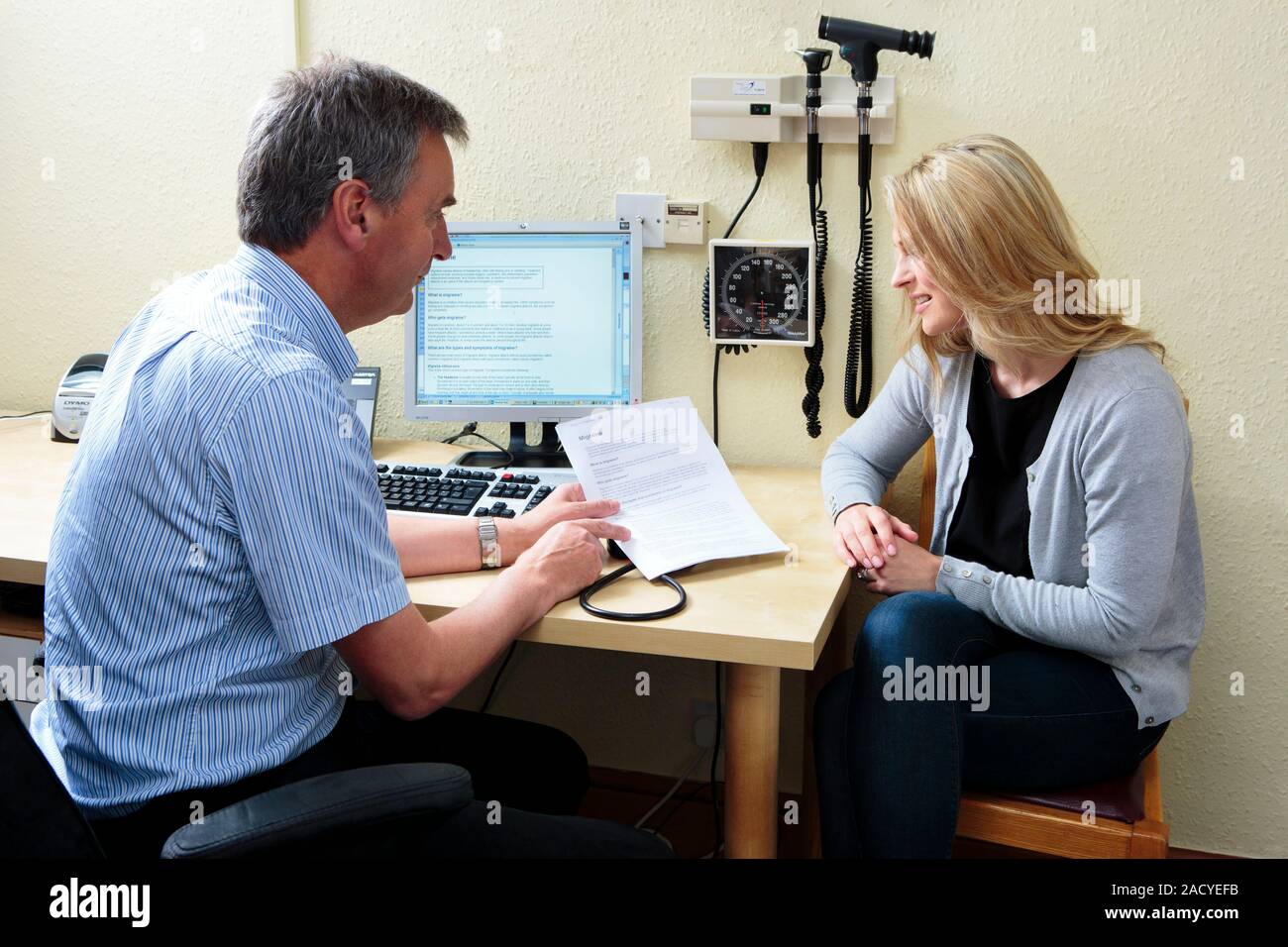 Migraine consultation. General practice doctor (GP) giving a female