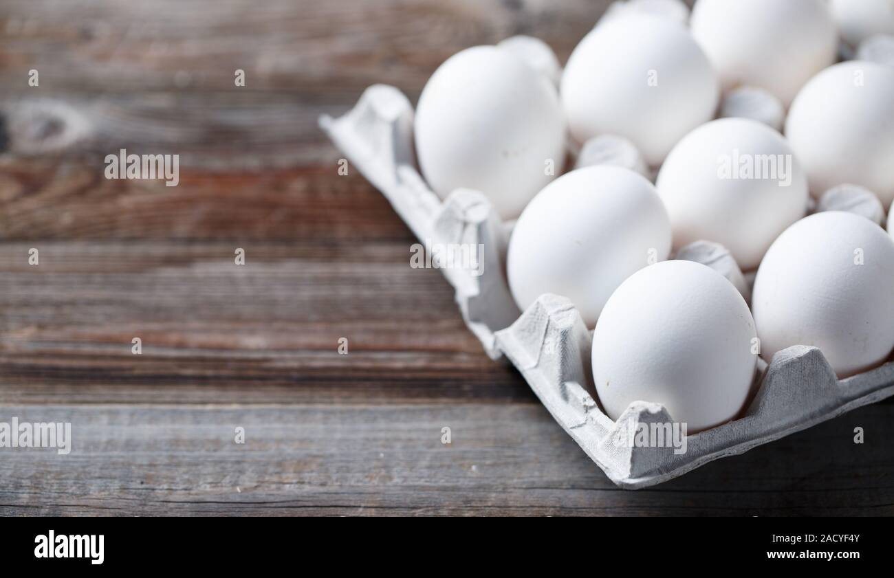 White eggs on a rustic wooden table Stock Photo