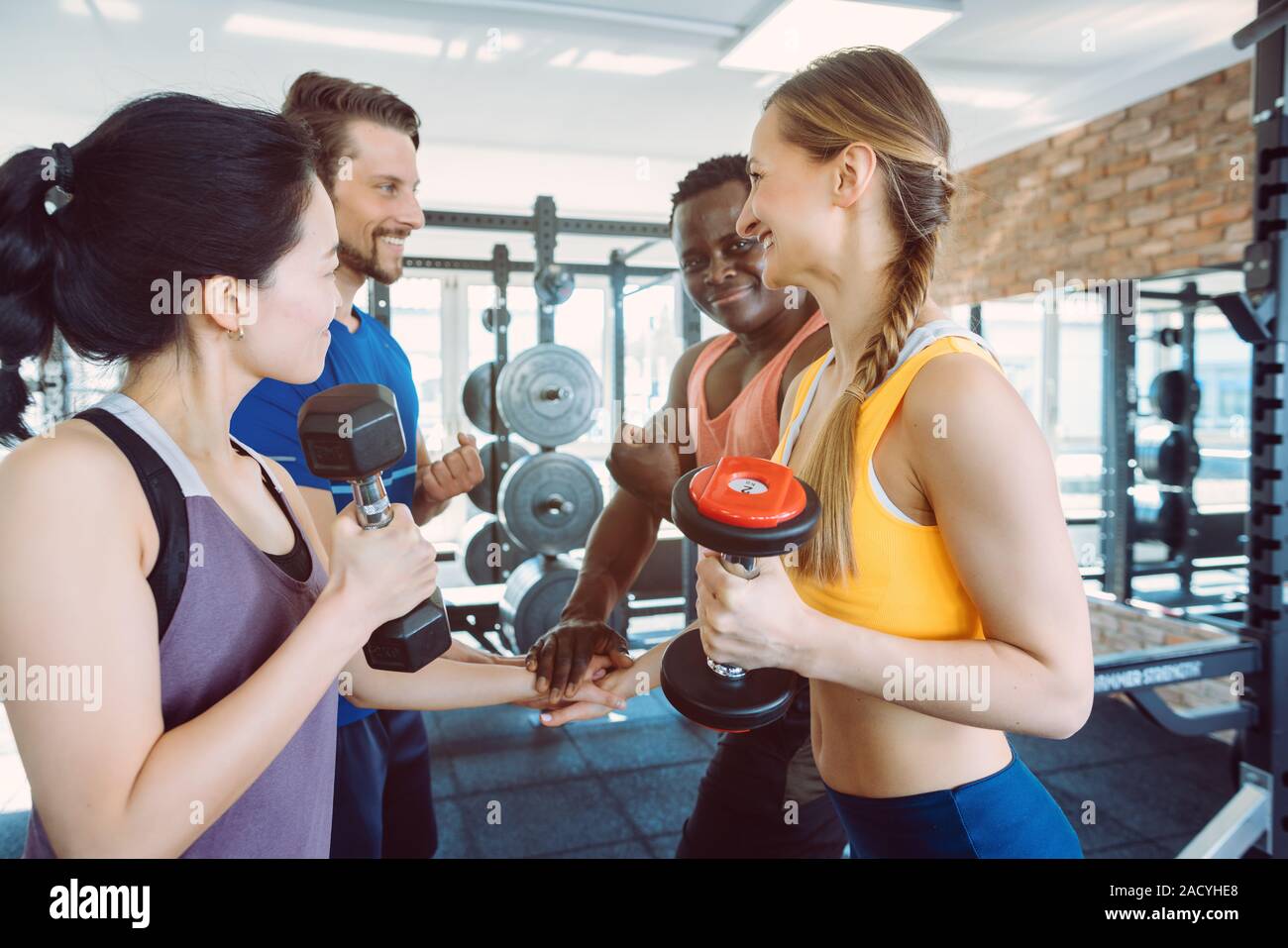 Four diversity friends during fitness training in gym Stock Photo
