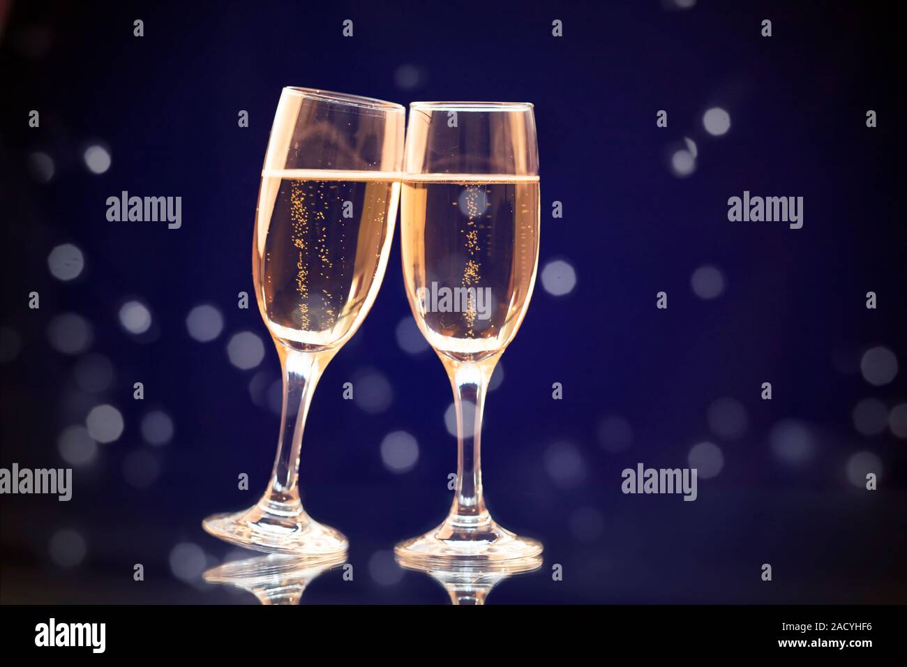 Champagne glasses on sparkling holiday background - Celebrating the New ...