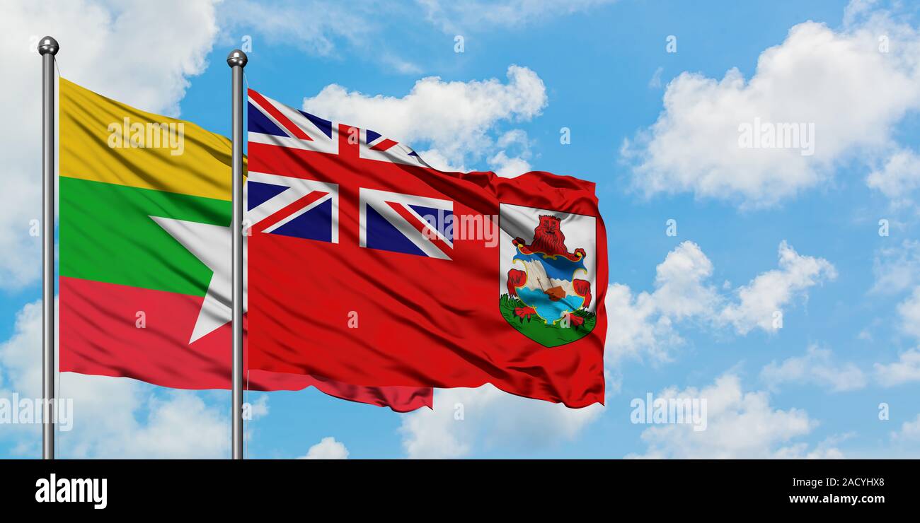 Myanmar and Bermuda flag waving in the wind against white cloudy blue sky together. Diplomacy concept, international relations. Stock Photo