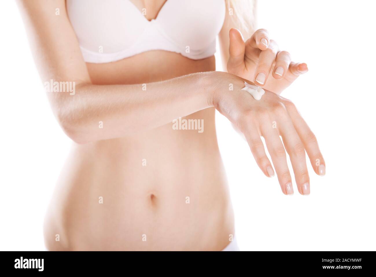 Woman applies cream on her hands isolated Stock Photo