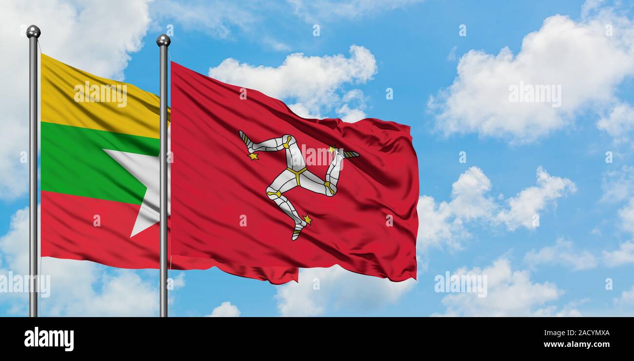 Myanmar and Isle Of Man flag waving in the wind against white cloudy ...