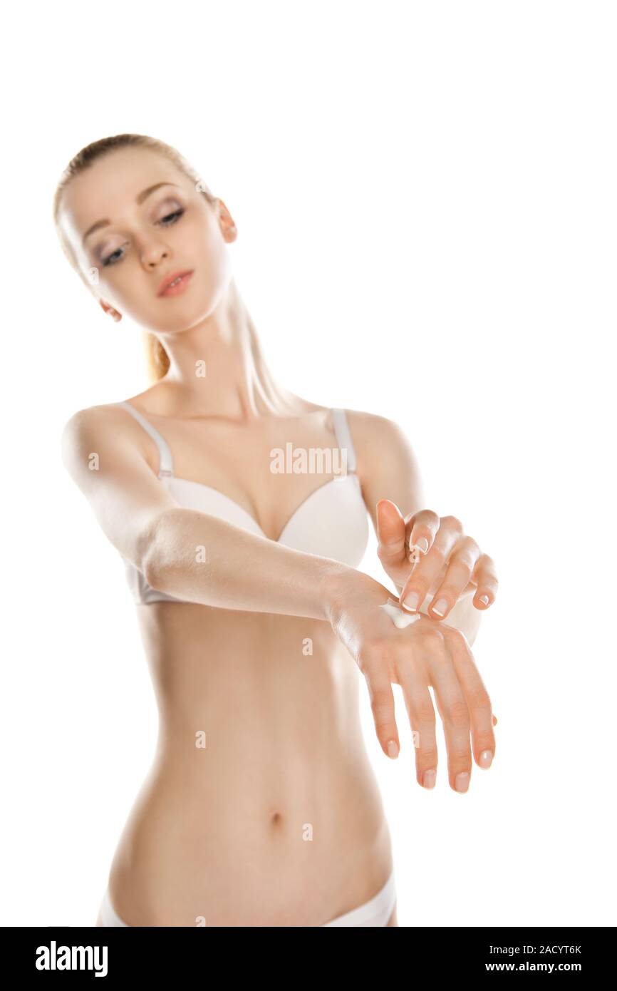 Woman applies cream on her hands isolated Stock Photo