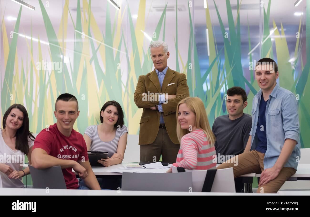 portrait of teacher with students group in background Stock Photo - Alamy