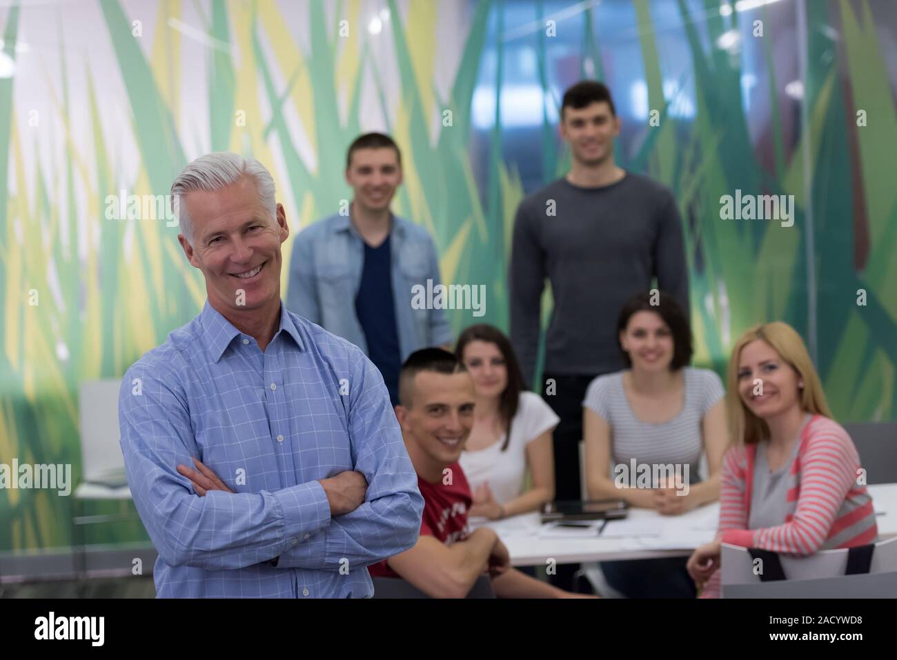 portrait of teacher with students group in background Stock Photo - Alamy