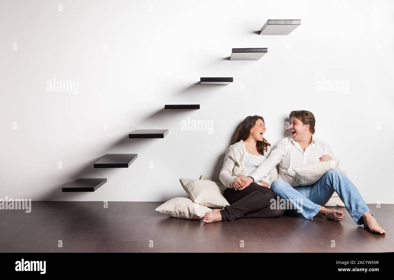 Couple at home sitting on stairs. Pregnancy Stock Photo Alamy