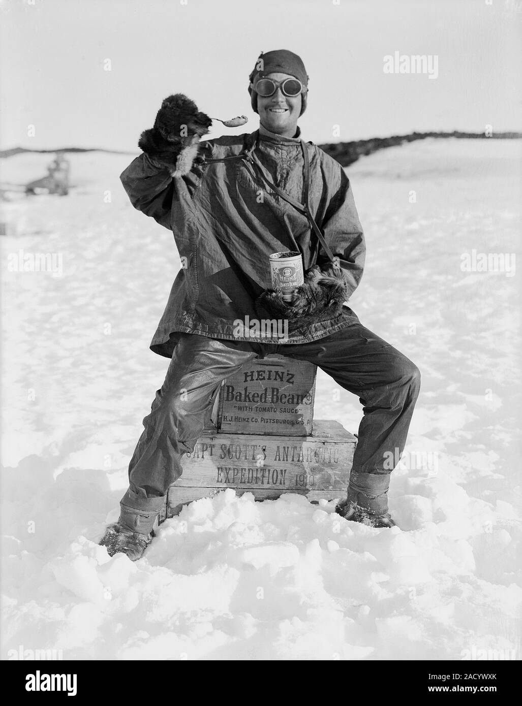 Heinz baked beans in Antarctica. Antarctic explorer sitting on crates
