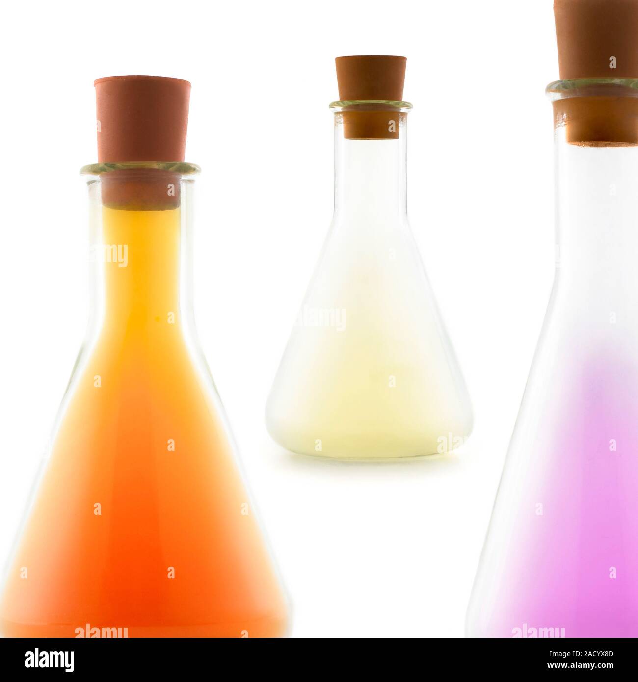 Three conical flasks, each containing a different halogen. They are