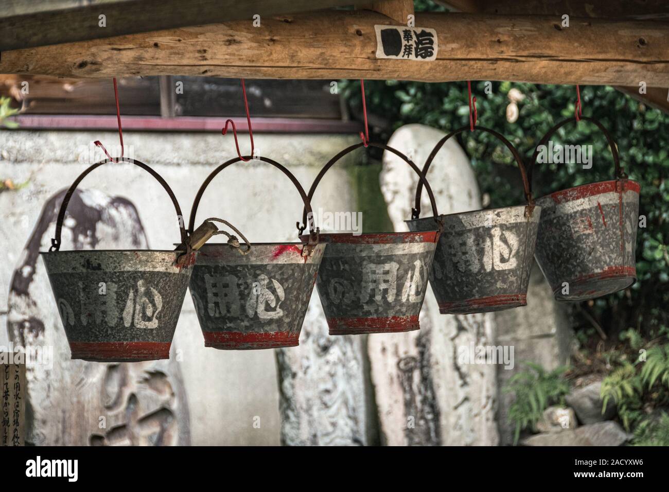 Water buckets hanging above the well in pictoresque village of Narai in Kiso Valley, Japan. Stock Photo