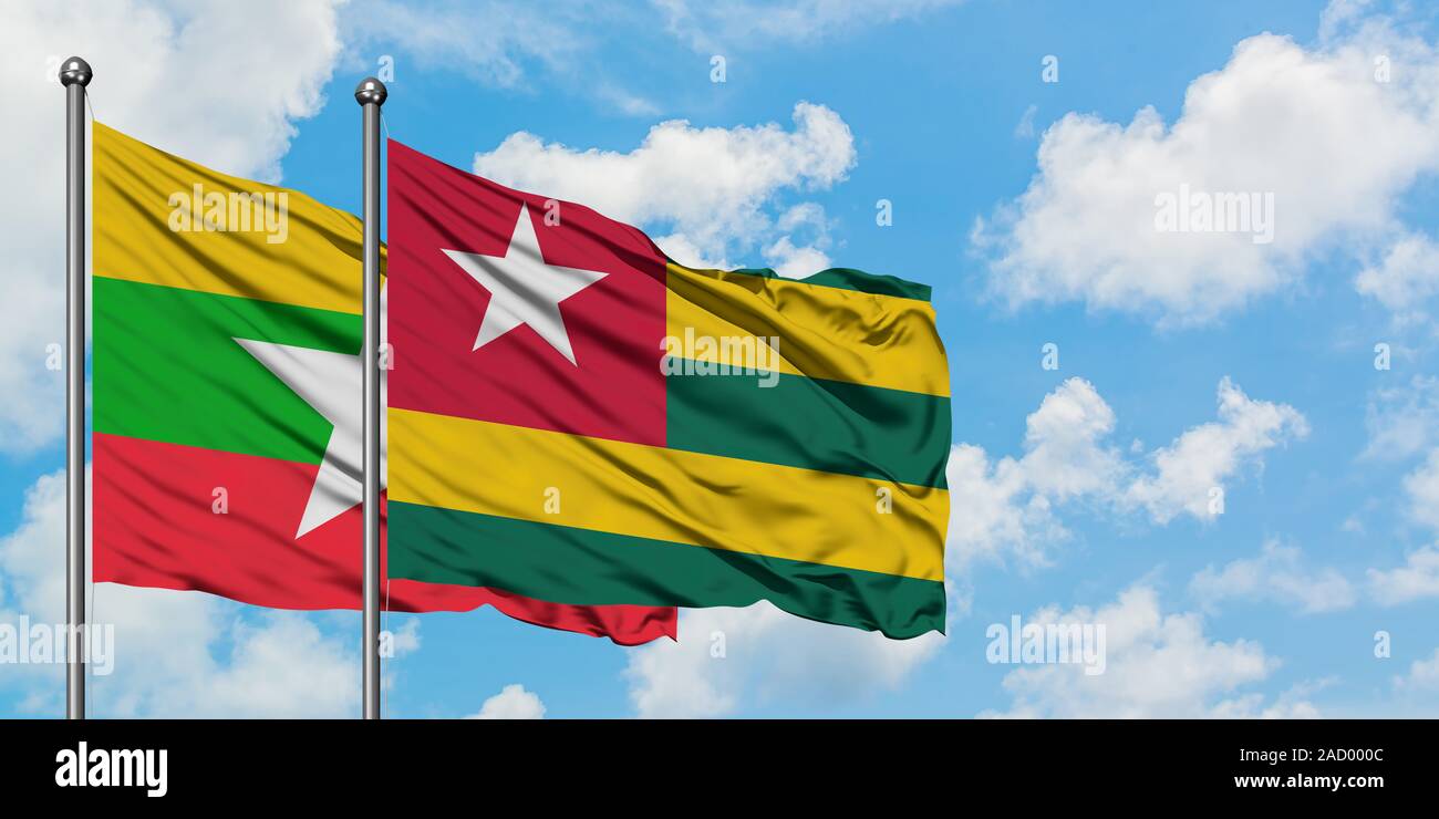 Myanmar and Togo flag waving in the wind against white cloudy blue sky ...