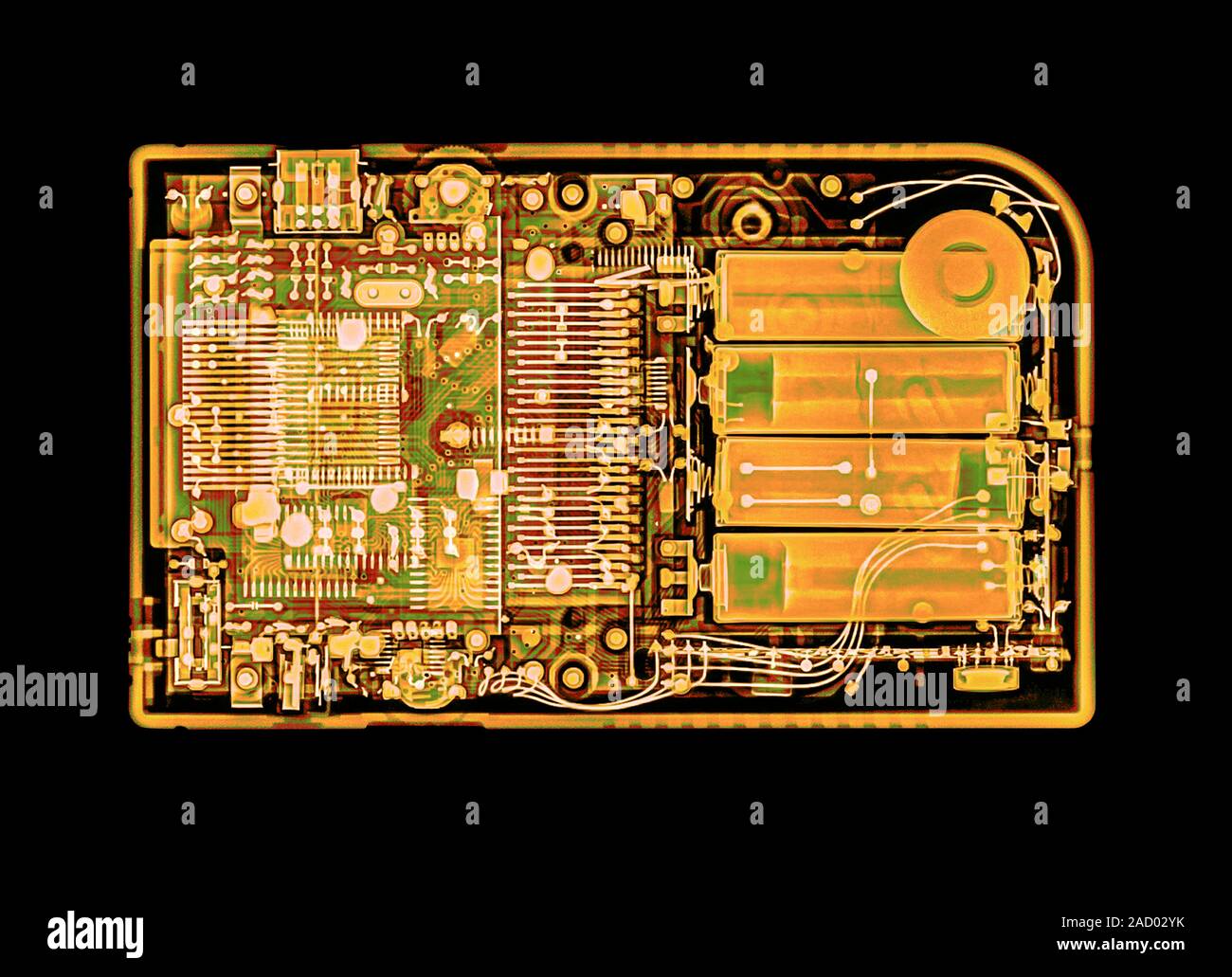 Coloured x-ray image of a handheld computer game device. Stock Photo