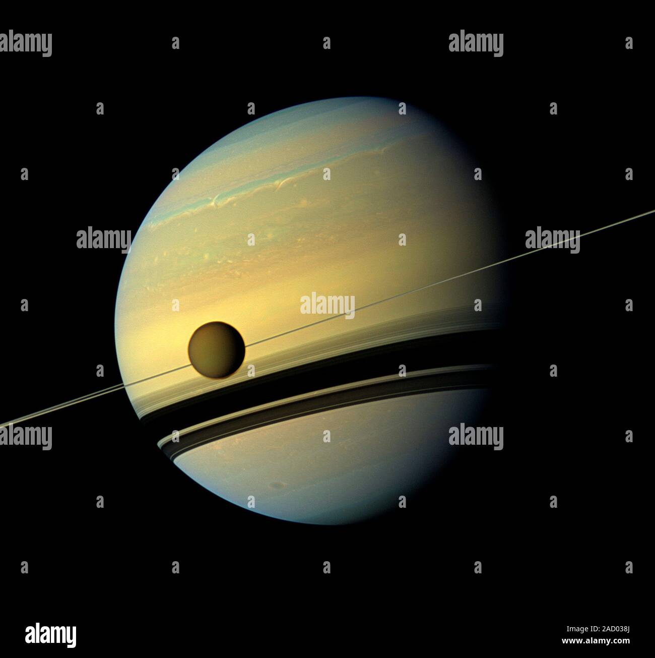 Titan and Saturn. View of Saturn (large) with its largest moon Titan ...