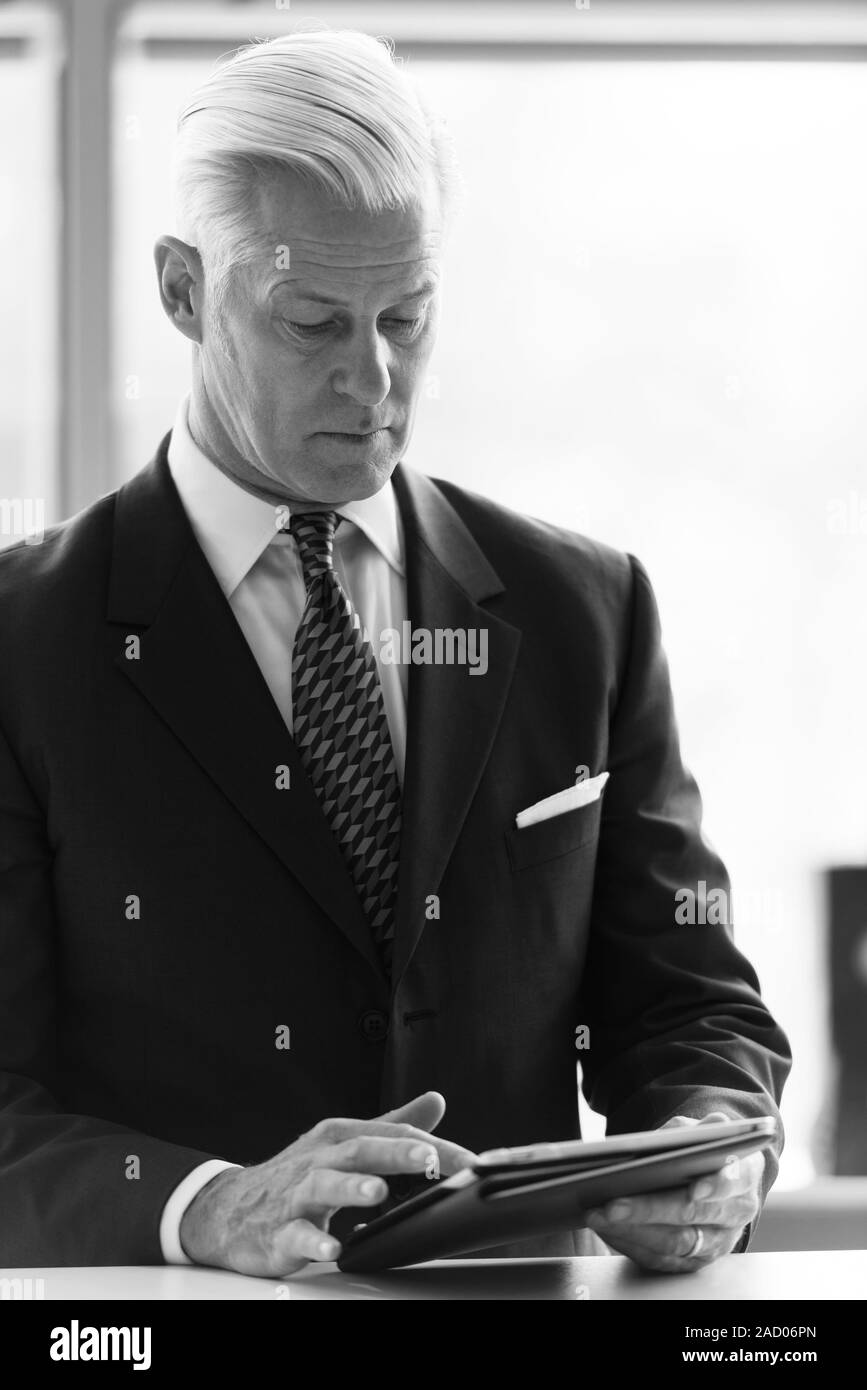 senior Business man working on tablet computer Stock Photo