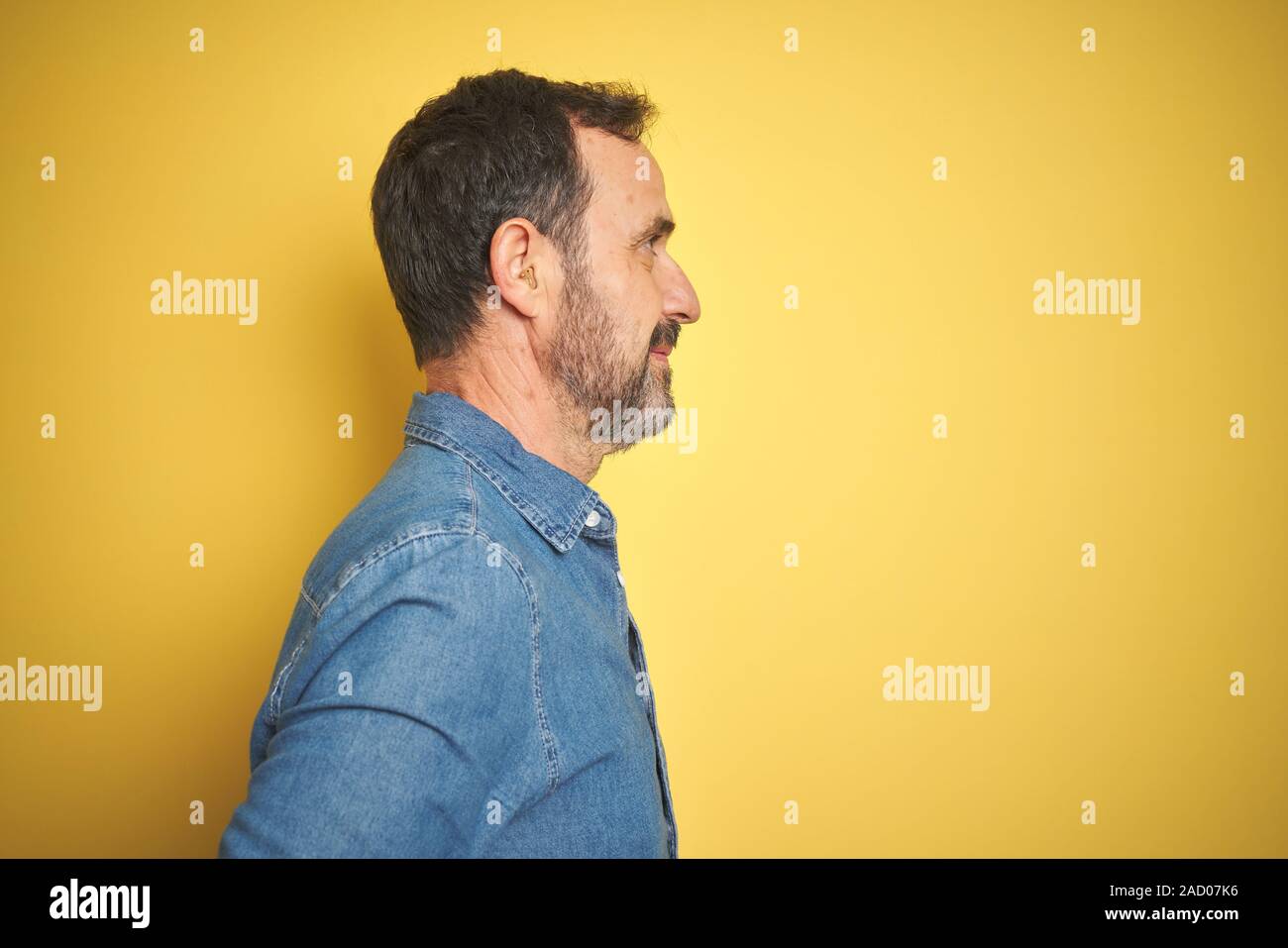Handsome Middle Age Senior Man With Grey Hair Over Isolated Yellow