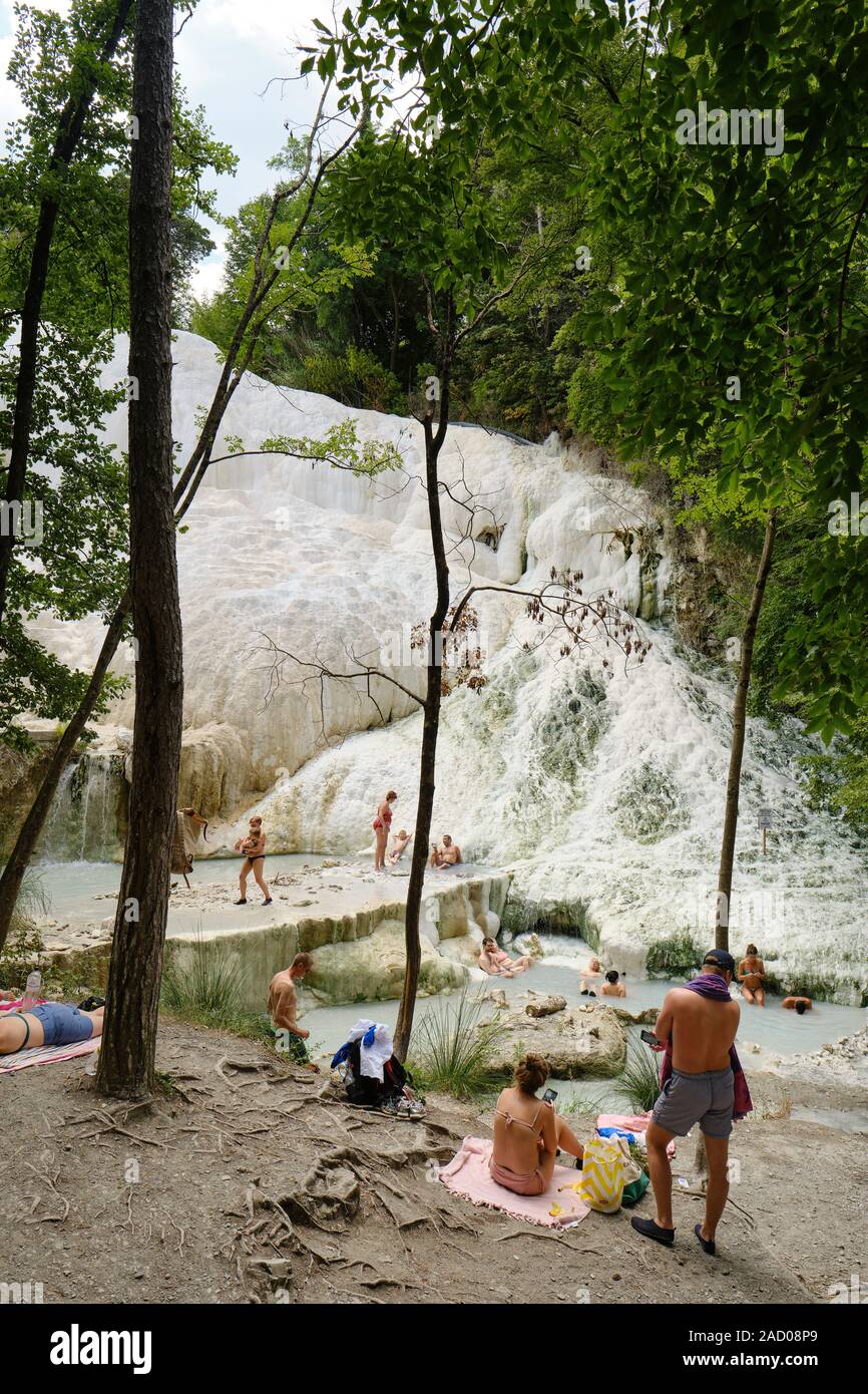 Bagni San Filippo natural hot springs, bathers and the white calcium concretion deposits waterfalls, Castiglione d'Orcia, Tuscany Italy Europe Stock Photo