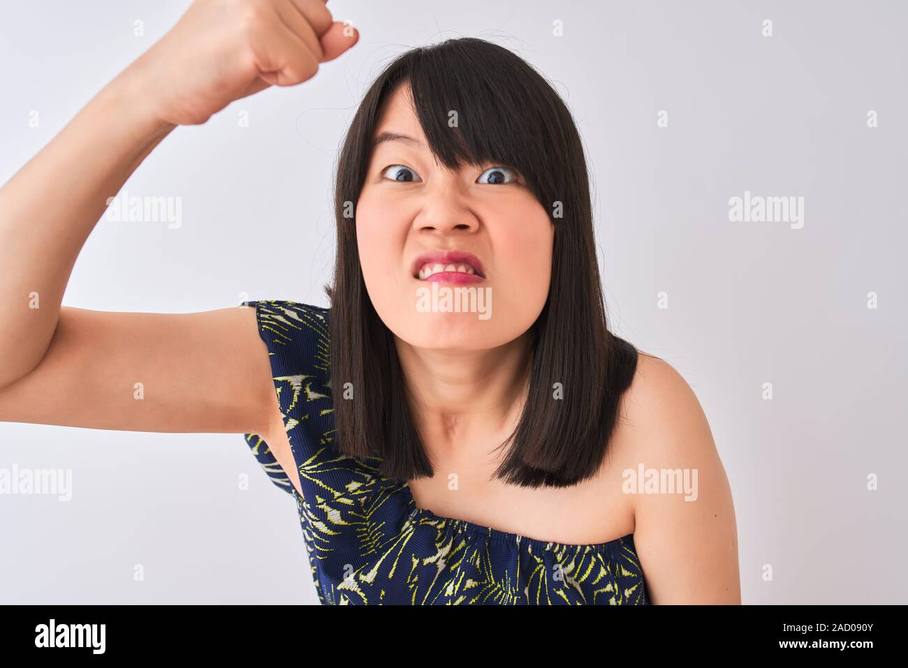 Young beautiful chinese woman wearing summer floral t-shirt over isolated  white background annoyed and frustrated shouting with anger, crazy and  yelli Stock Photo - Alamy