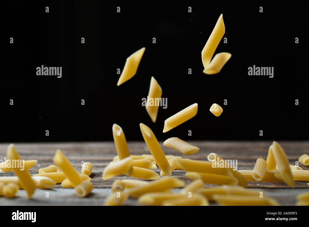Download Falling Penne Pasta Flying Yellow Raw Macaroni Over Black Background Stock Photo Alamy Yellowimages Mockups