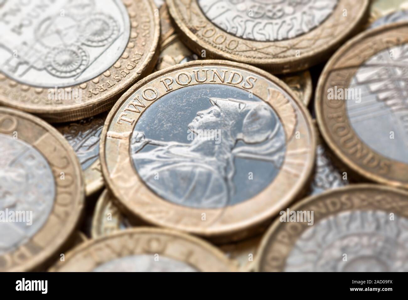 Close up of a pile of British Two Pound Coins with selective focus on the words 'Two Pounds' Stock Photo