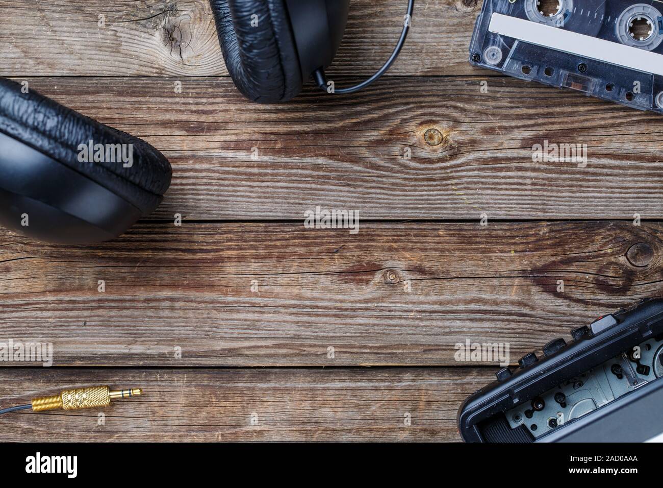 Cassette tapes, player and headphones over wooden table. top view. Stock Photo