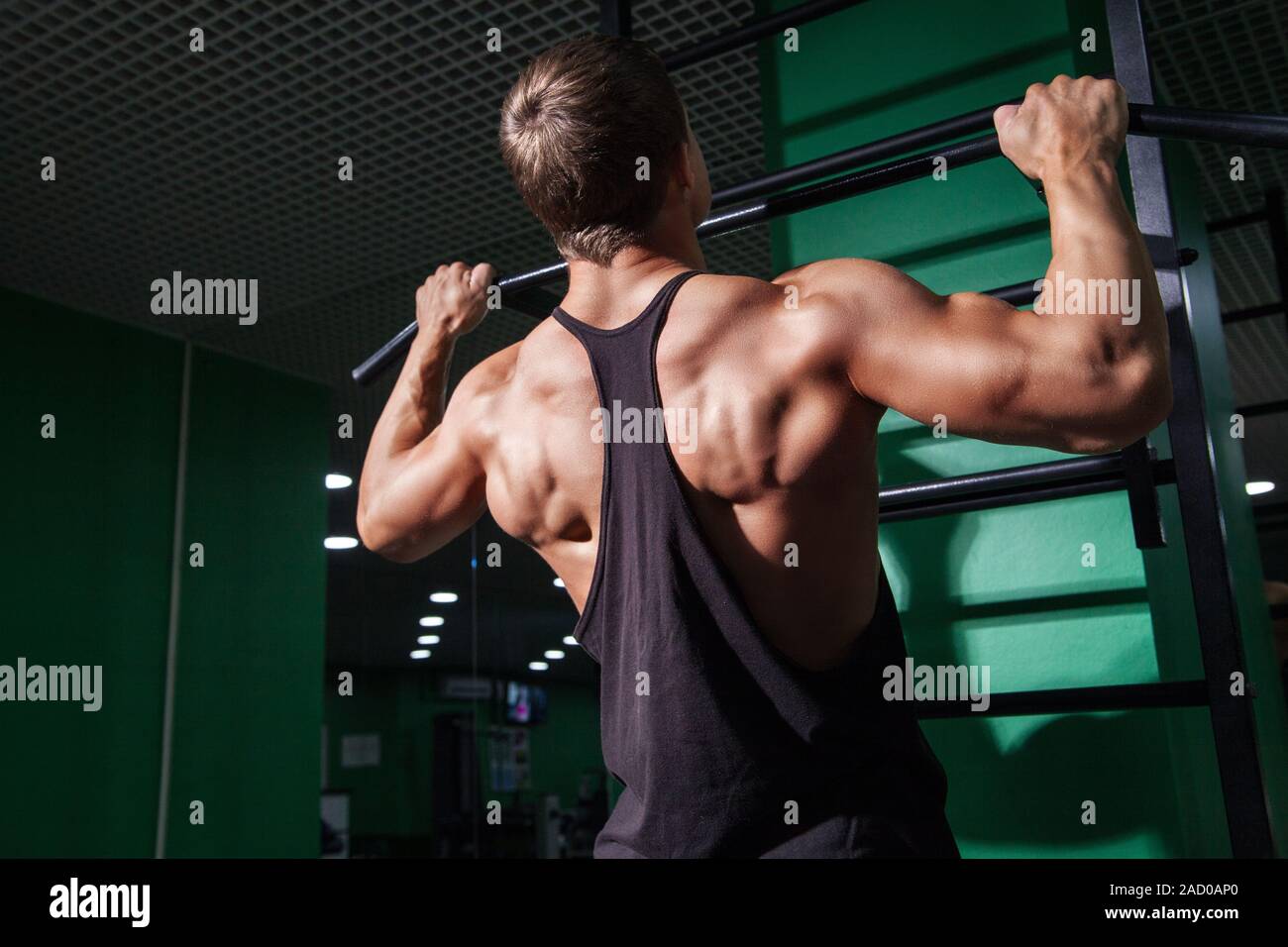 Back view of young man doing pull ups Stock Photo