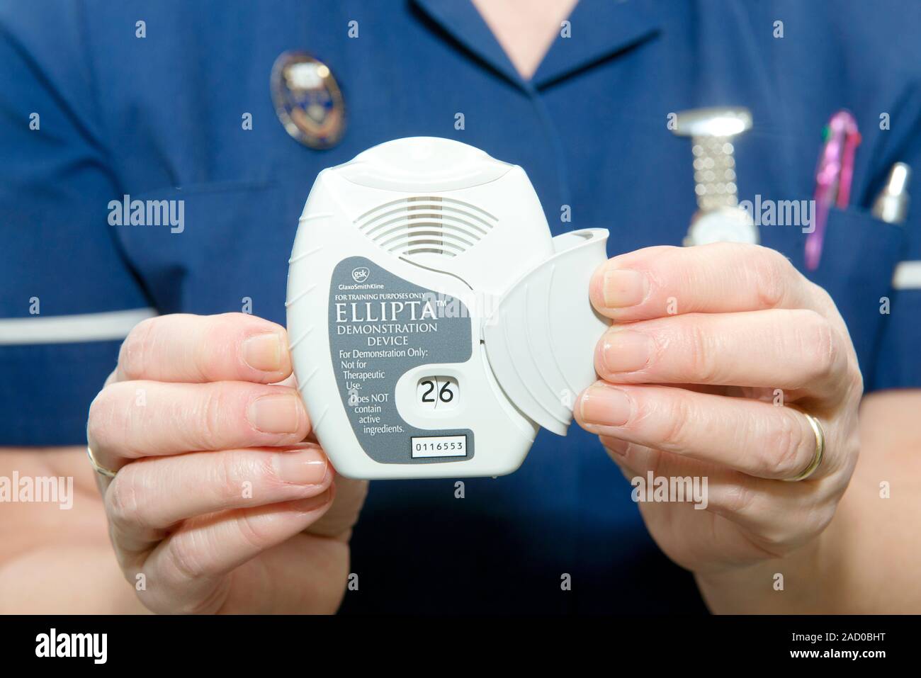 Training inhaler. Nurse holding an Ellipta demonstration inhaler used