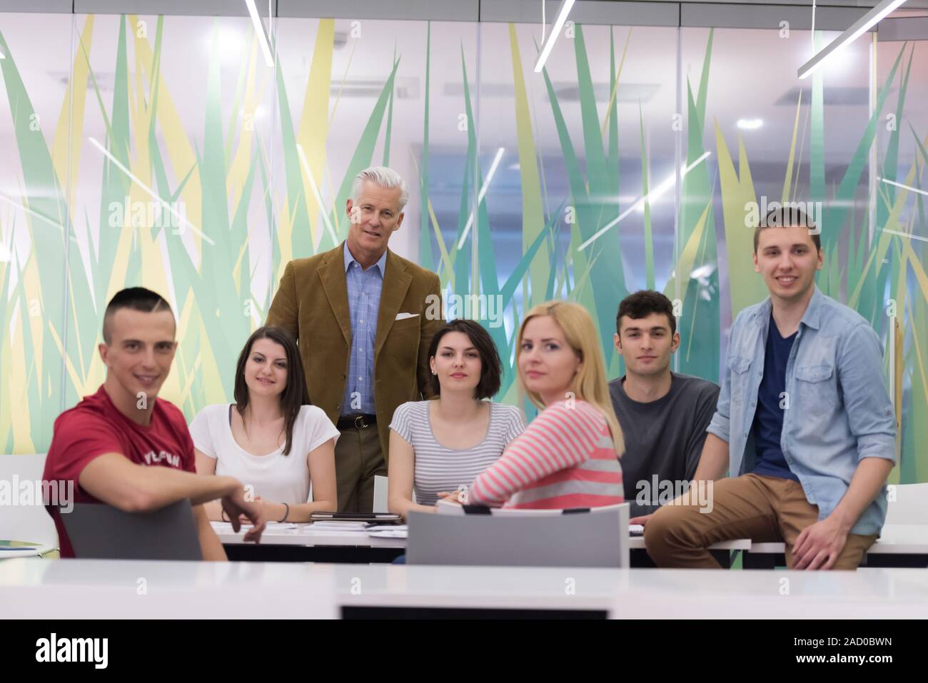 portrait of teacher with students group in background Stock Photo - Alamy
