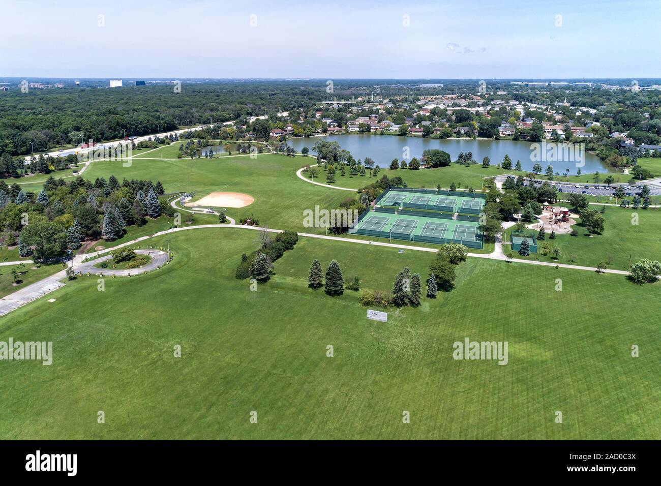 Aerial view of a suburban park district area with a soccer field, tennis courts, lake and playground in Northbrook, IL. USA Stock Photo
