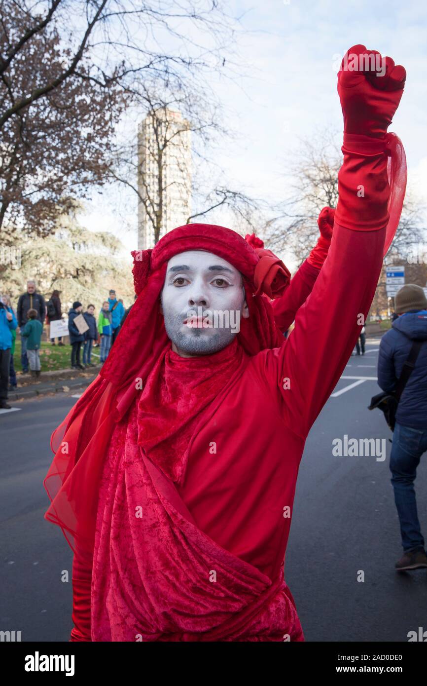 November 29, 2019 - Cologne, Germany. The performance group Red Rebels of Extinction Rebellion at the Fridays for Future climate strike. 4th global da Stock Photo