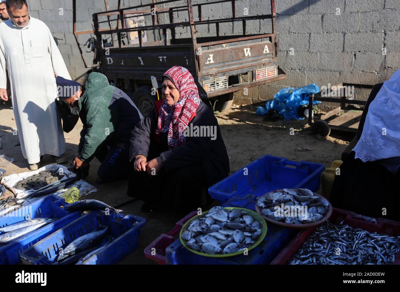 Deir Al Balah, Gaza Strip, Palestinian Territory. 3rd Dec, 2019. Palestinian fisherwoman Um Jimal al-Akra, selling fish at a market in Gaza City, on December 03, 2019. After she returns to Gaza City with fish, Um Jimal competes with other traders at the fishmarket in Deir Al Balah district, where the most significant source of living is fishing industry Credit: Ashraf Amra/APA Images/ZUMA Wire/Alamy Live News Stock Photo