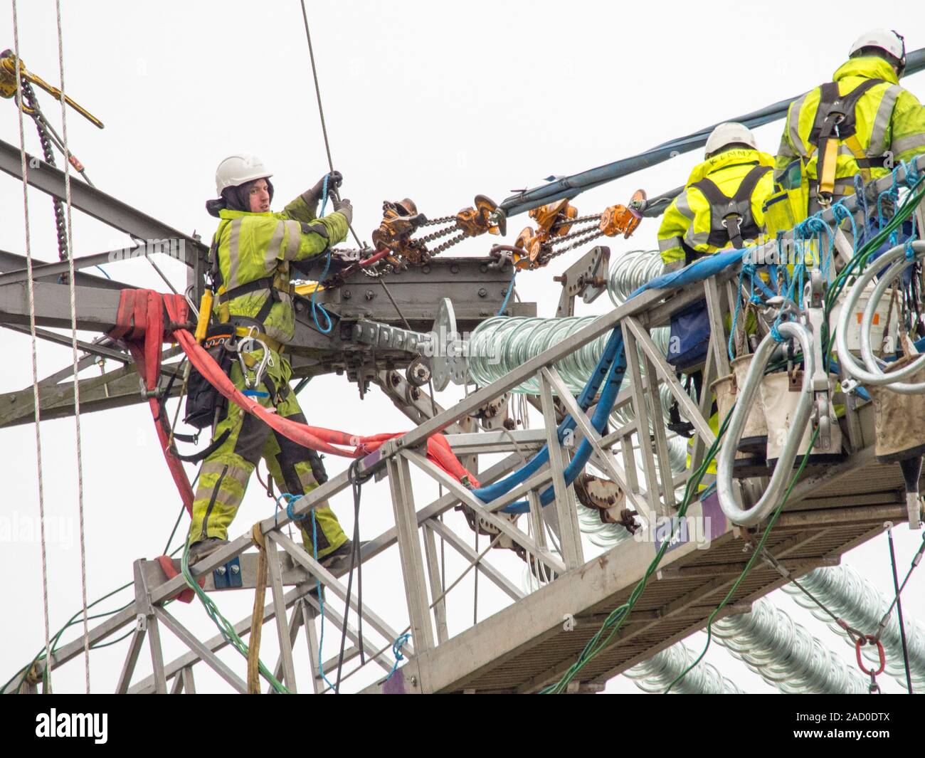 Technicians working to replace old insulators on a pylon in Barrow on Soar, Leicestershire, UK. Stock Photo