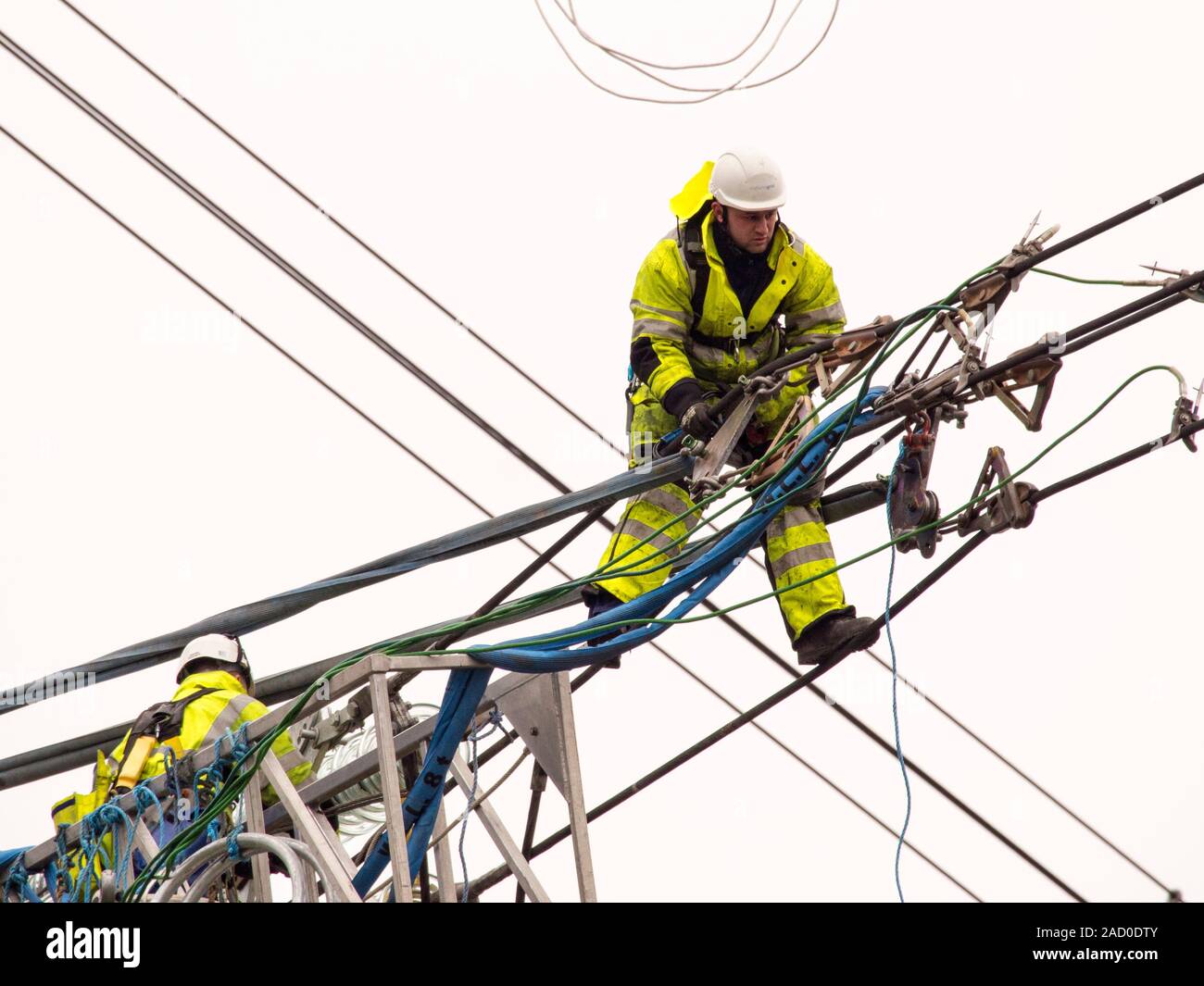 Technicians working to replace old insulators on a pylon in Barrow on Soar, Leicestershire, UK. Stock Photo