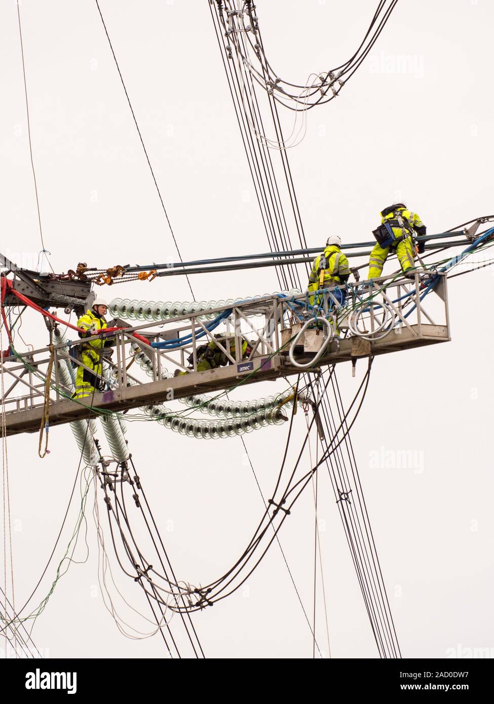 Technicians working to replace old insulators on a pylon in Barrow on Soar, Leicestershire, UK. Stock Photo
