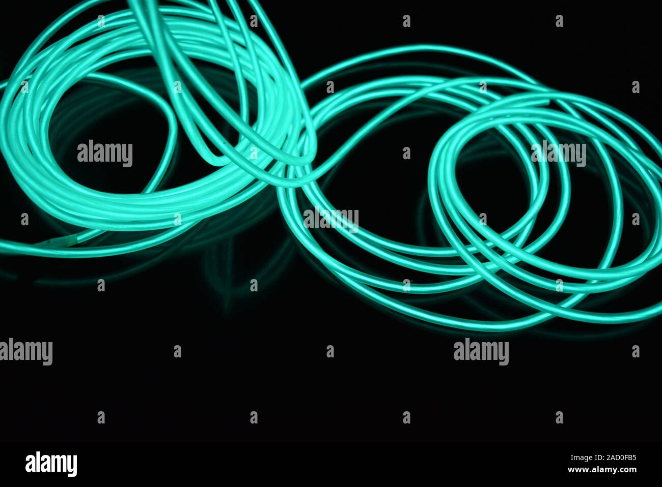 Unusual bright wires made of turquoise colored material glowing at