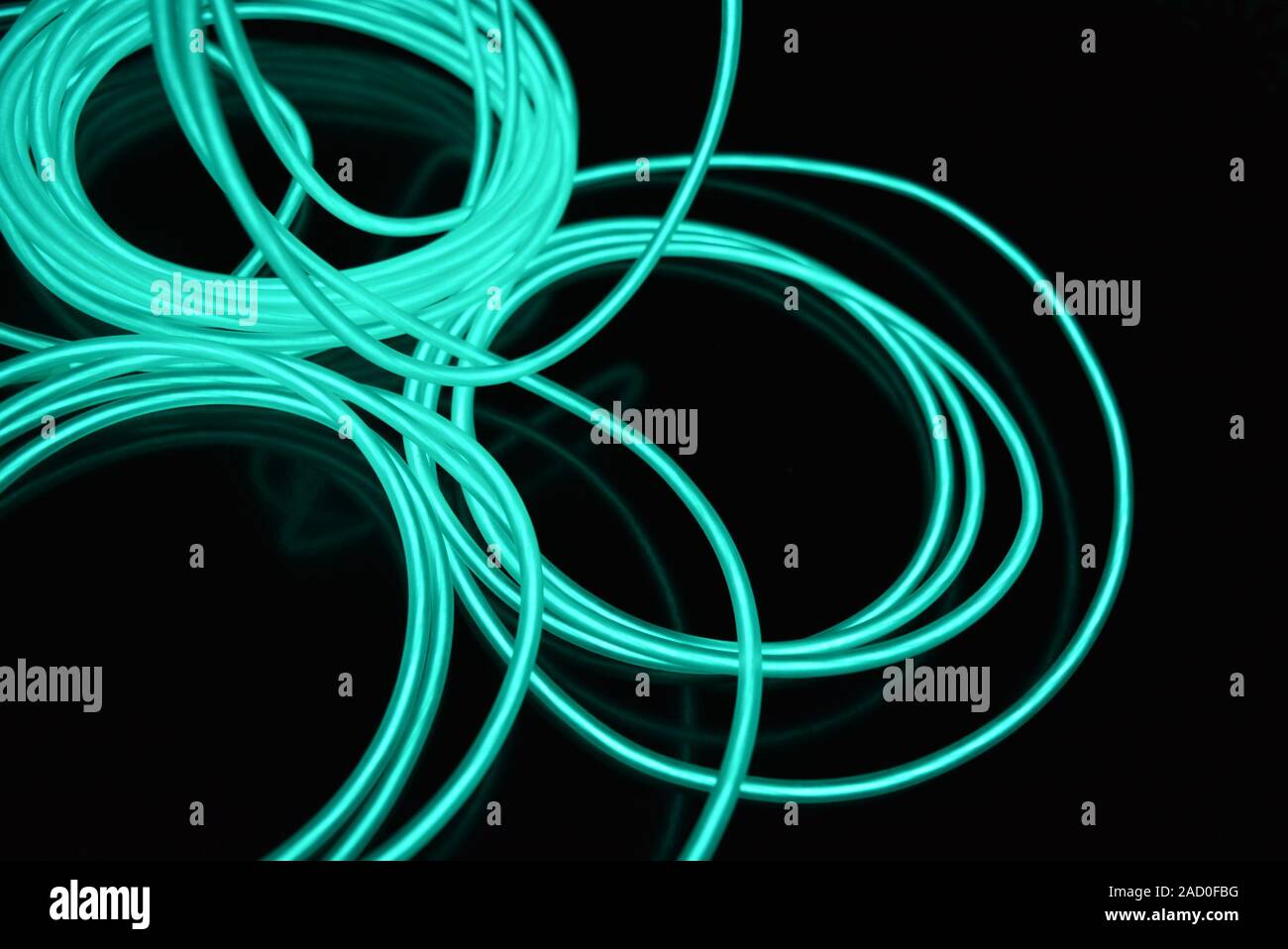 Unusual bright wires made of turquoisecolored material glowing at