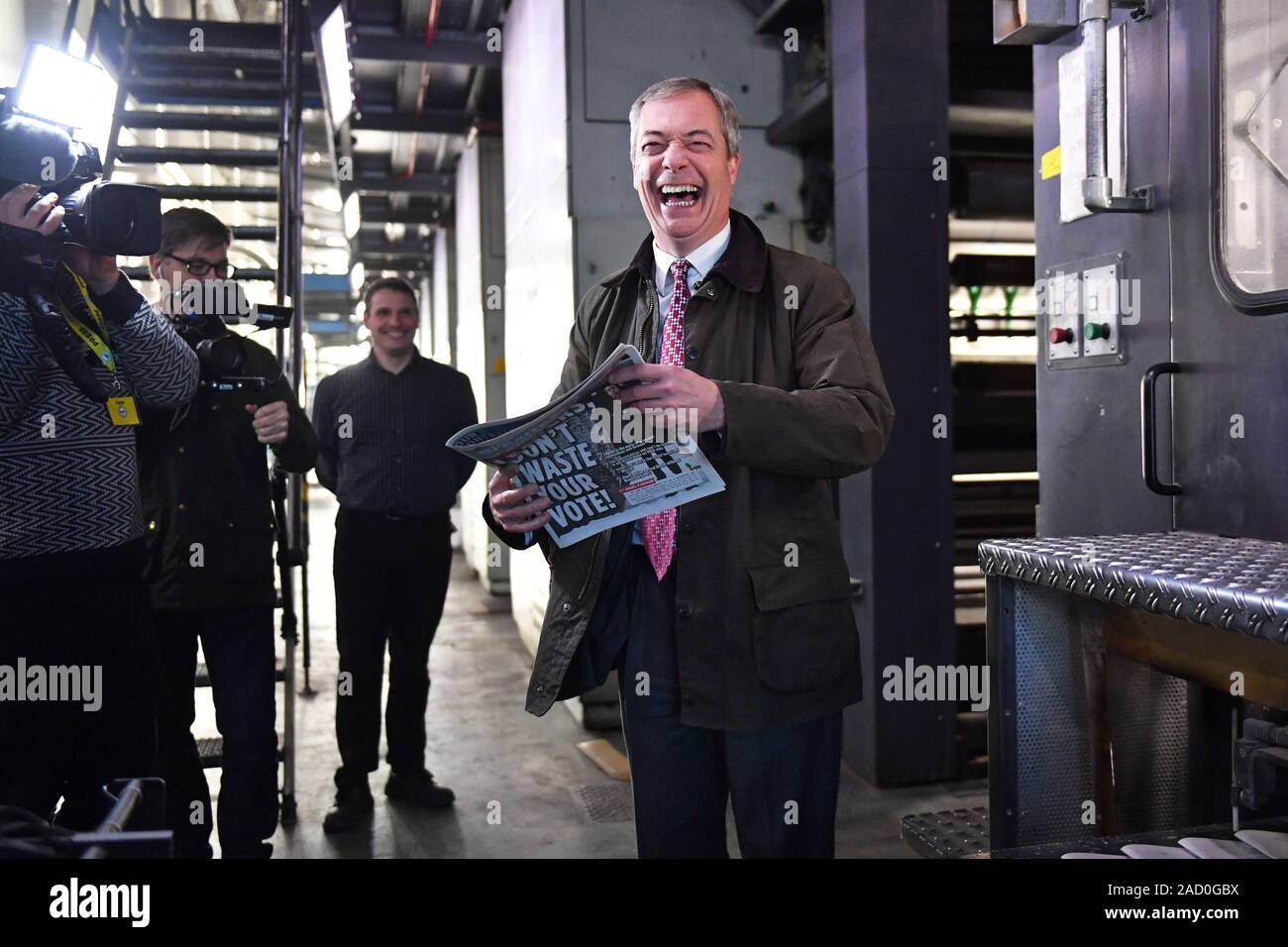 Brexit Party leader Nigel Farage picks up a copy of The Brexiteer during a visit to JPI Printers in Dinnington, South Yorkshire, whilst on the General Election campaign trail. Stock Photo