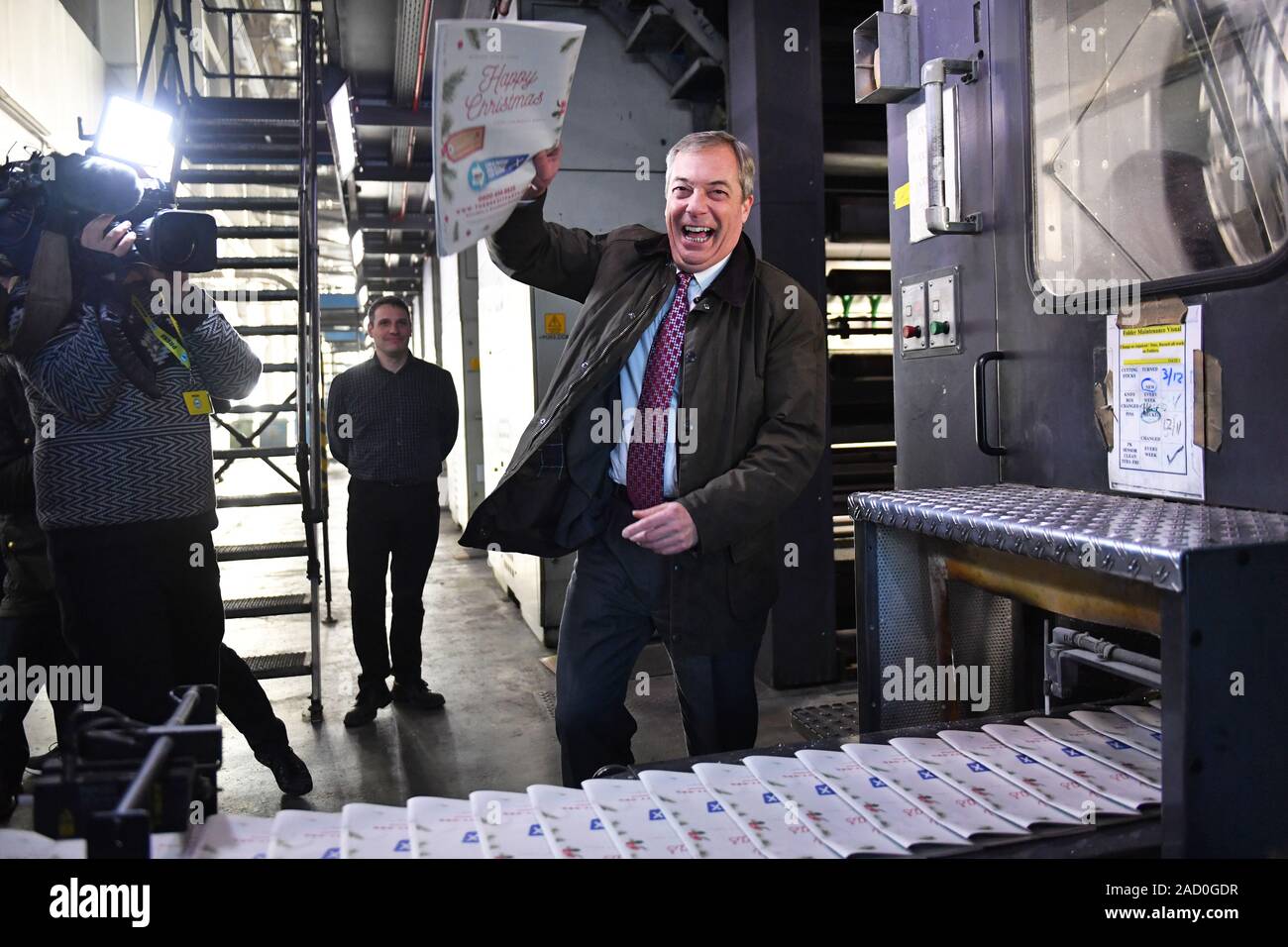 Brexit Party leader Nigel Farage picks up a copy of The Brexiteer during a visit to JPI Printers in Dinnington, South Yorkshire, whilst on the General Election campaign trail. Stock Photo