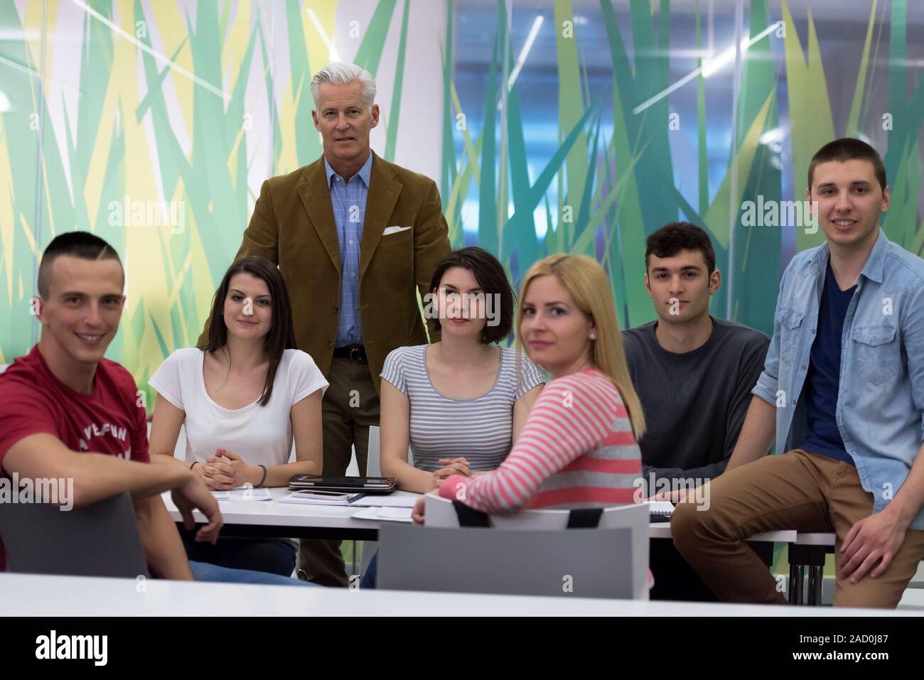 portrait of teacher with students group in background Stock Photo - Alamy