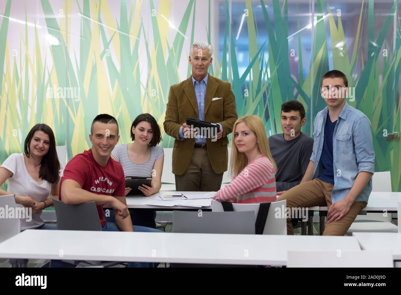 portrait of teacher with students group in background Stock Photo - Alamy