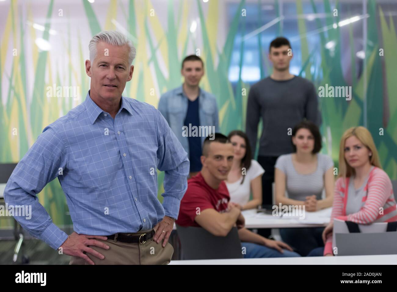 portrait of teacher with students group in background Stock Photo - Alamy