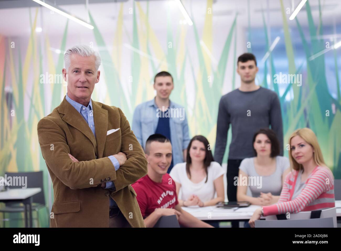 portrait of teacher with students group in background Stock Photo - Alamy