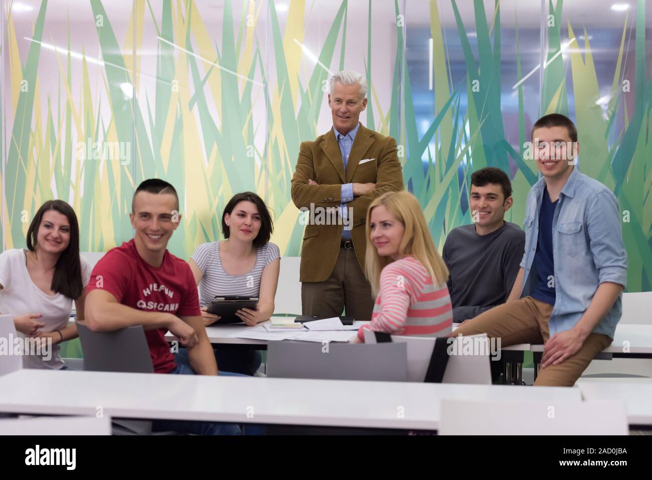 portrait of teacher with students group in background Stock Photo - Alamy