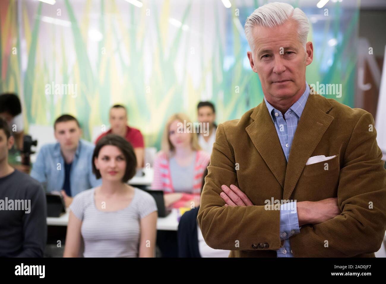 portrait of teacher with students group in background Stock Photo - Alamy