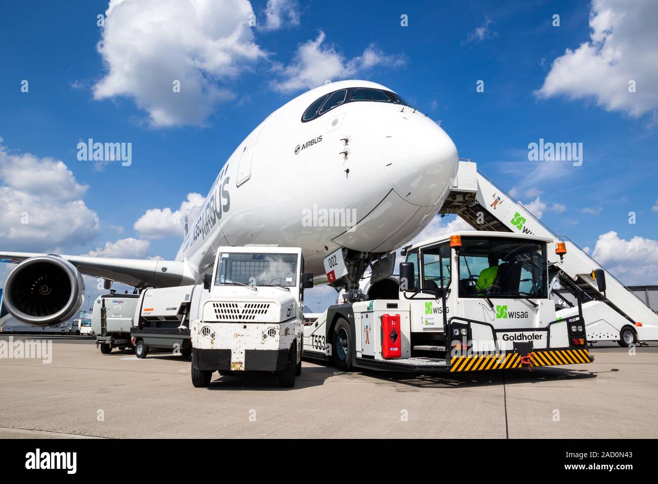BERLIN, GERMANY - APR 27, 2018: New modern Airbus A350 XWB passenger jet plane about to be towed by an airport towing vehicle on Berlin-Schonefeld Int Stock Photo