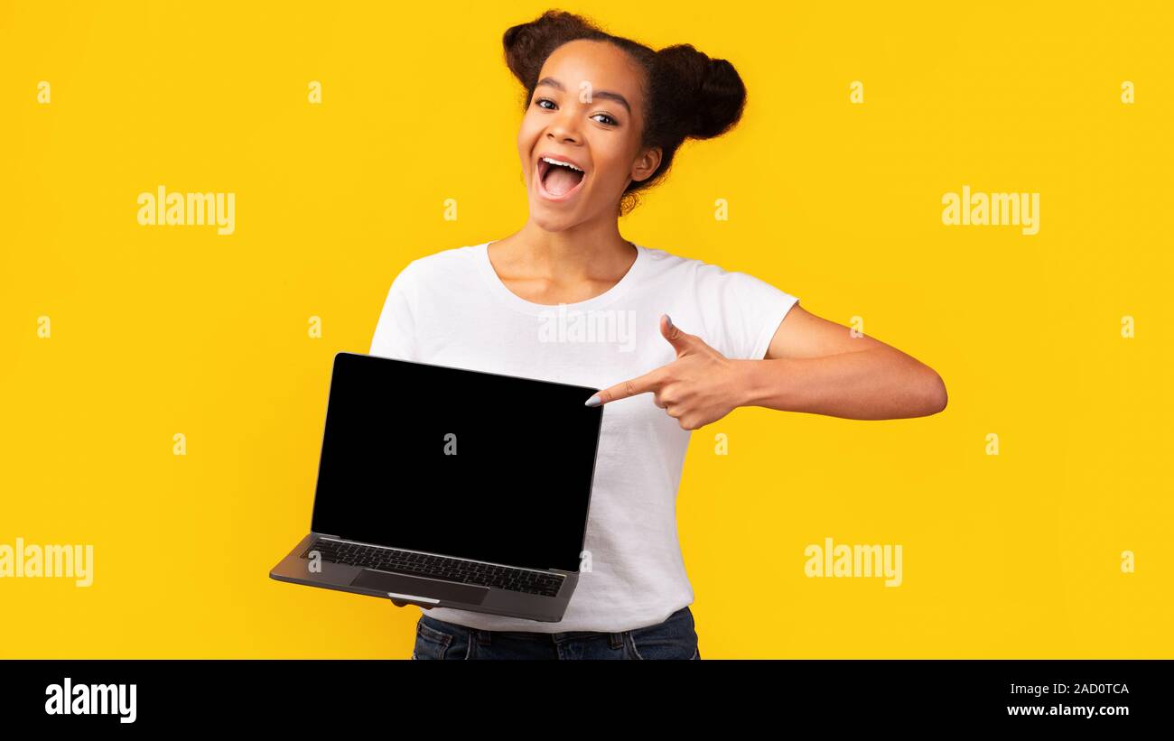 Happy african teenager pointing at blank laptop screen Stock Photo - Alamy