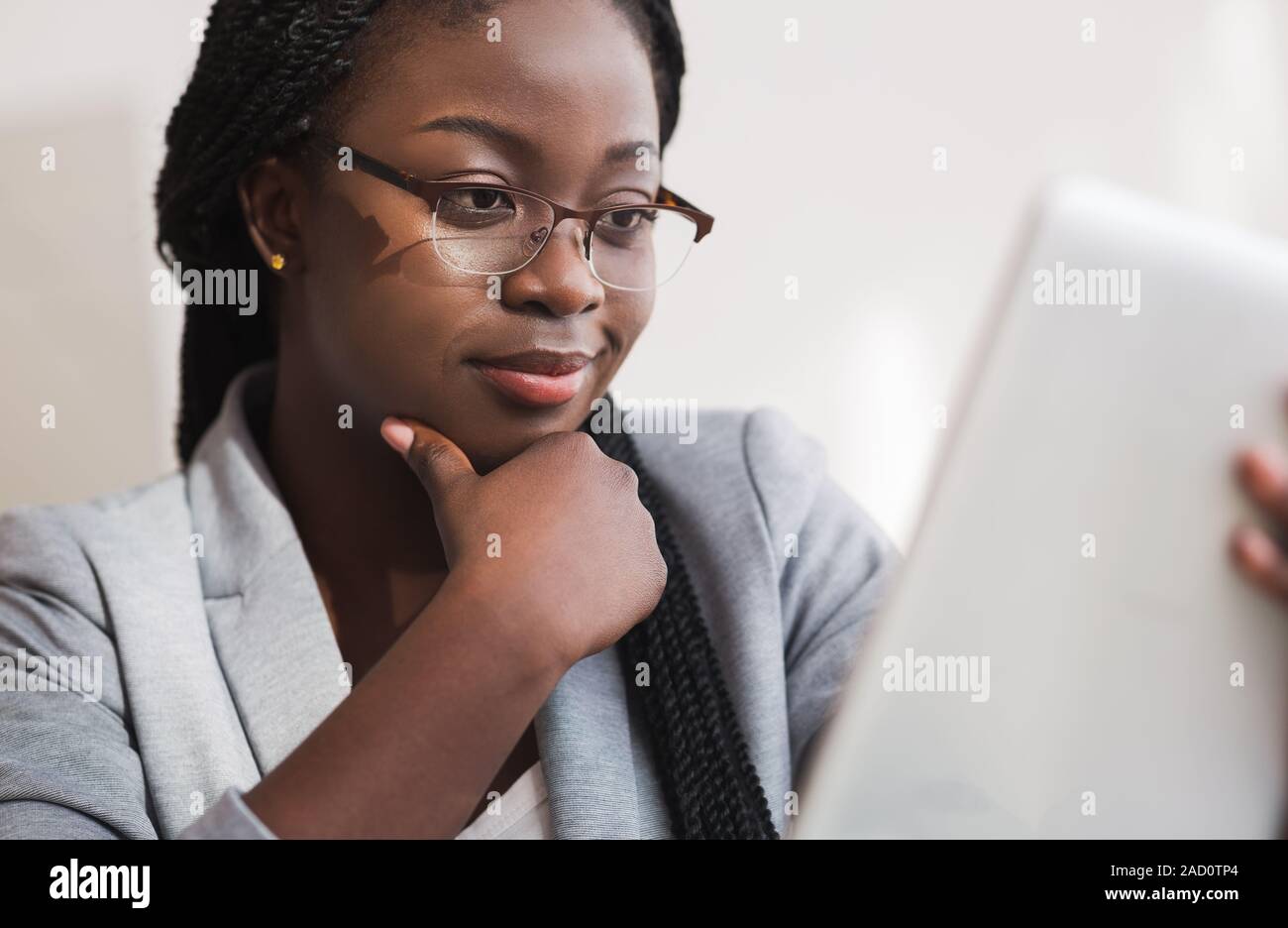 Cleseup Portrait Of Professional Financial Consultant In Glasses Using Digital Tablet Stock Photo